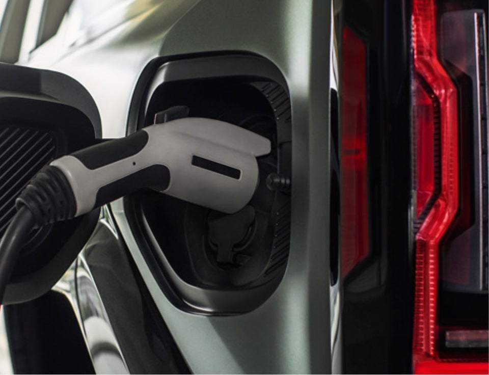 Close up of charging port with charger plugged in on a GMC Hummer EV SUV - Alpena GMC in ALPENA MI